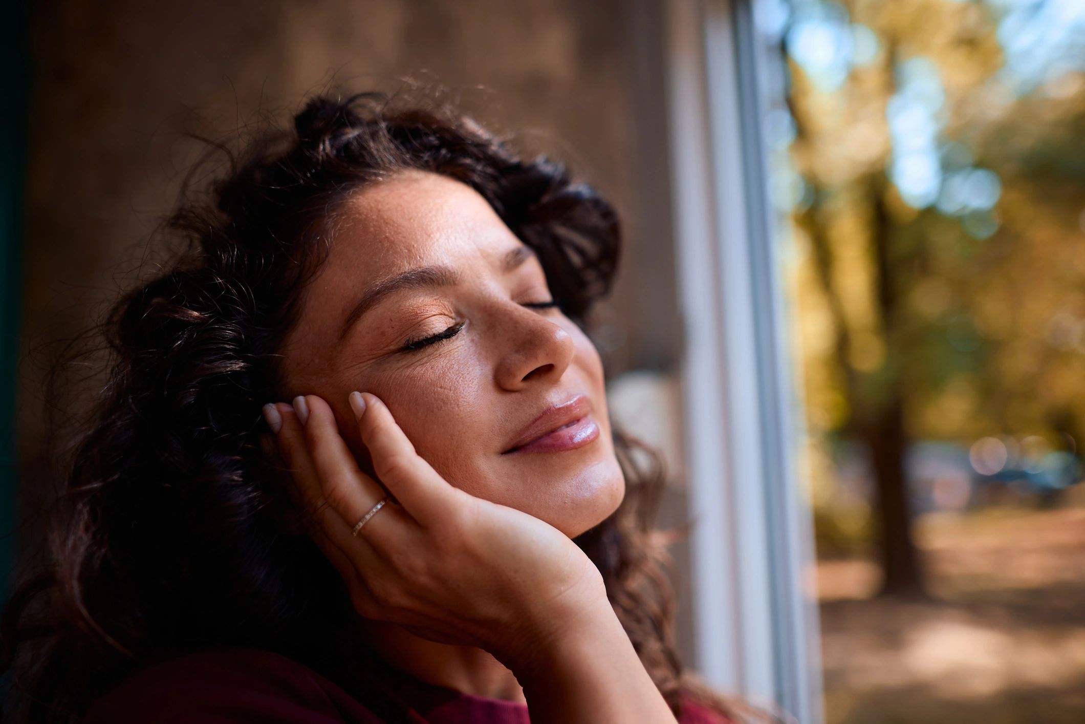 Contemplative woman in natural light